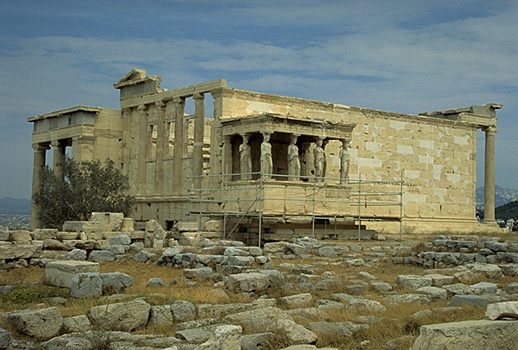 General view of the Erechtheion from the southwest, showing the North Porch (at left), the - The blue limestone foundations of the Old Athena Temple (built c. 510-500 BC and destroyed by the Persians in 480 BC) are visible in the foreground. Photo taken in 1998. by Kevin T. Glowacki and Nancy L. Klein