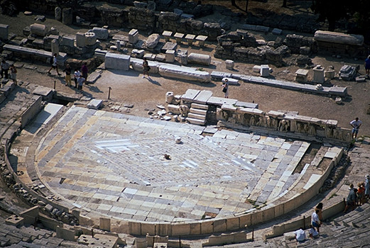 The Theater of Dionysos. - Detail of the orchestra and skene, incuding the Bema of Phaidros. View from the north (from the south wall of the Acropolis). Photo taken in 1998. by Kevin T. Glowacki and Nancy L. Klein