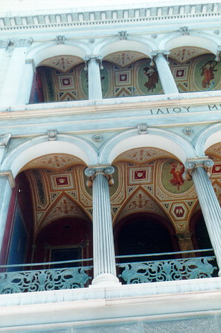Iliou Melathron (Mansion) facade - The facade is decorated from down to two-stories upwards by rows of Ionian style columns. The interior has been affluently garnished by Pompeian wall paintings and other decorative wall and ceiling illustrations. It is considered to be Hernest Ziller's